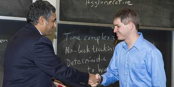 Prof. Chandrakasan, left, shook hands with Sprowls Awardee Austin Clements.