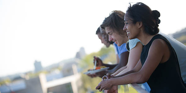 A group of SuperUROPs enjoys a post-event celebratory moment on the deck of the Media Lab.
