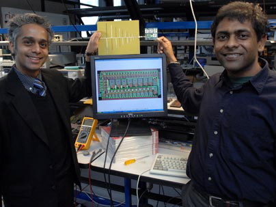 Associate Professor of Electrical Engineering Rahul Sarpeshkar, left, and Soumyajit Mandal display their RF (radio frequency) cochlea, a low-power, ultra-broadband radio chip. The chip, held by Mandal, is attached to an antenna, held by Sarpeshkar. The diagram on the computer monitor shows the wiring layout of the chip. Photo / Donna Coveney