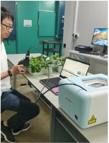 SMART - Portable leaf-clip Raman sensor being used at TLL to detect nutrient stress in leafy vegetables.png