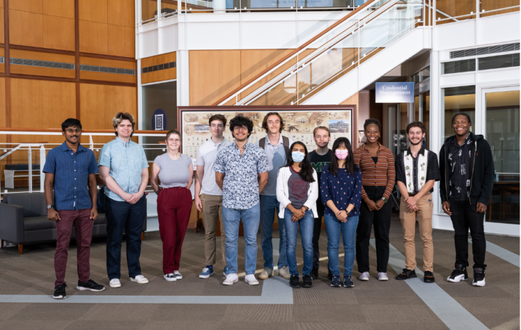 A row of students stand in the lobby of MIT's Lincoln Laboratory.