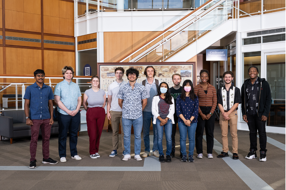 A row of students stand in the lobby of MIT's Lincoln Laboratory.