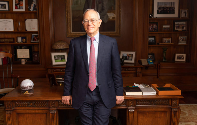 President L. Rafael Reif stands in front of his desk.