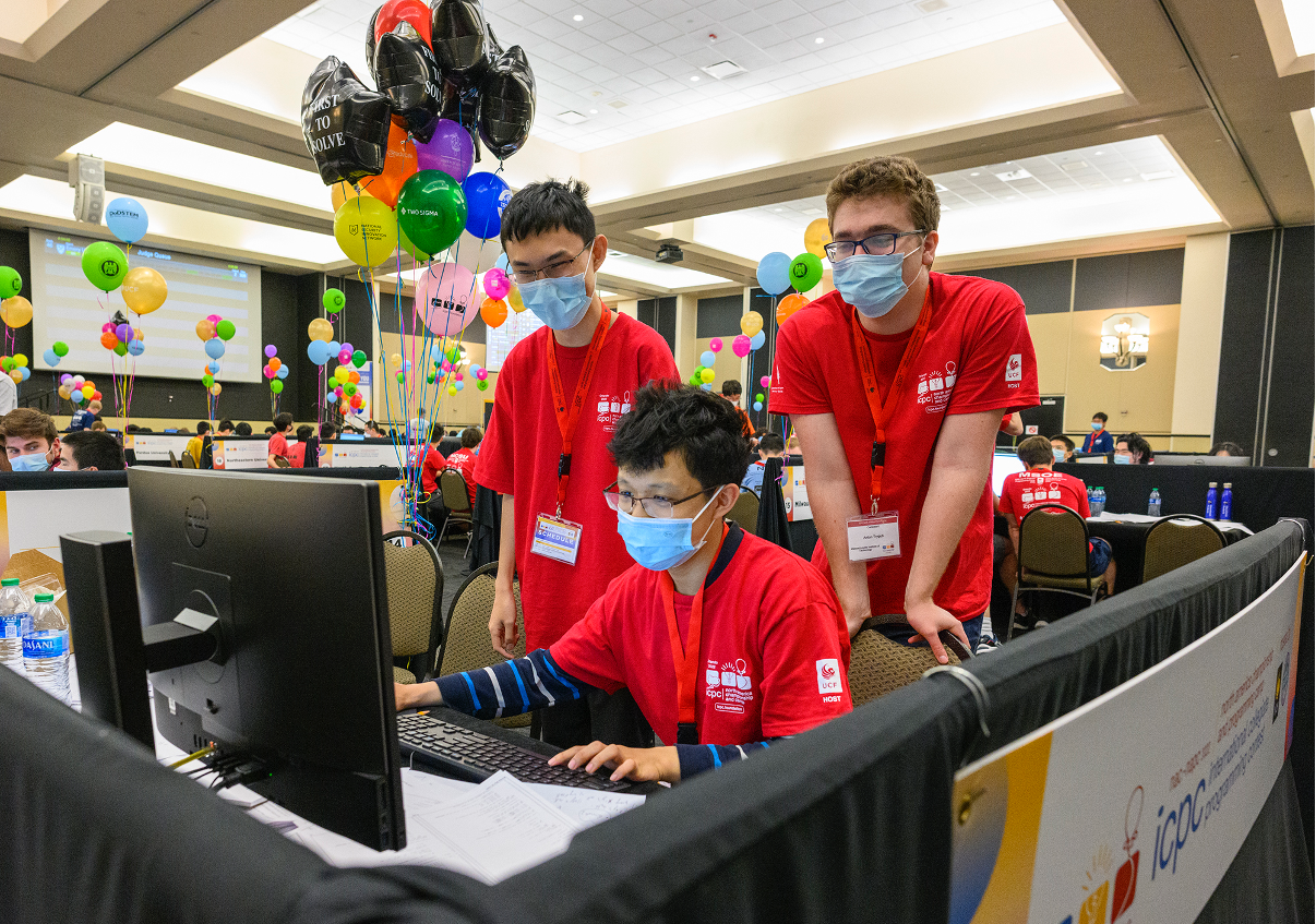 Sharing a single computer, Ziqian Zhong, MingYang Deng, and Anton Trygub work on their coding solution.