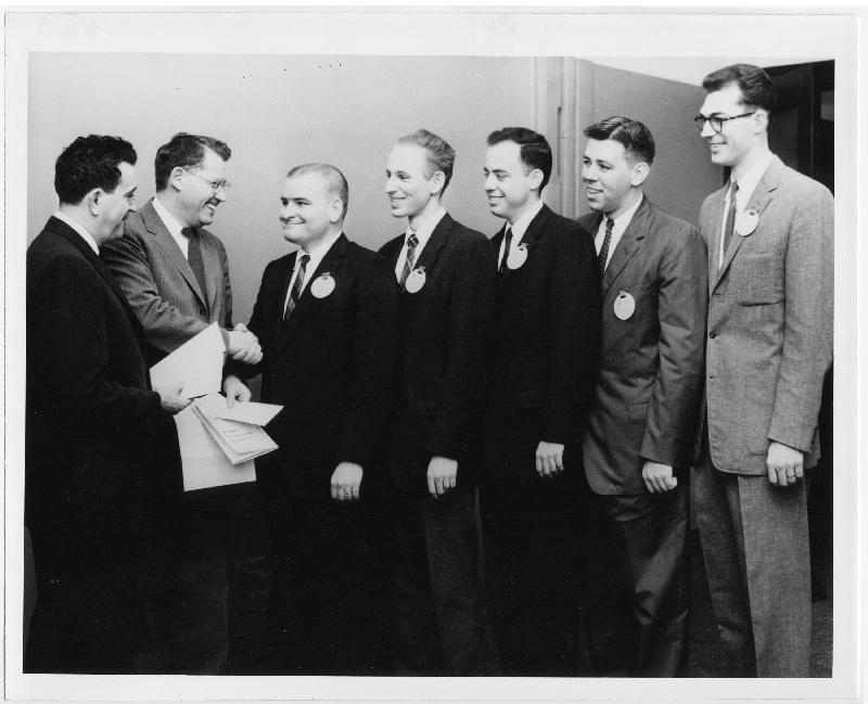 In this black-and-white image held by the MIT Museum, Fred Hennie stands third from the right in a row of graduate students receiving Excellence in Teaching Awards. 