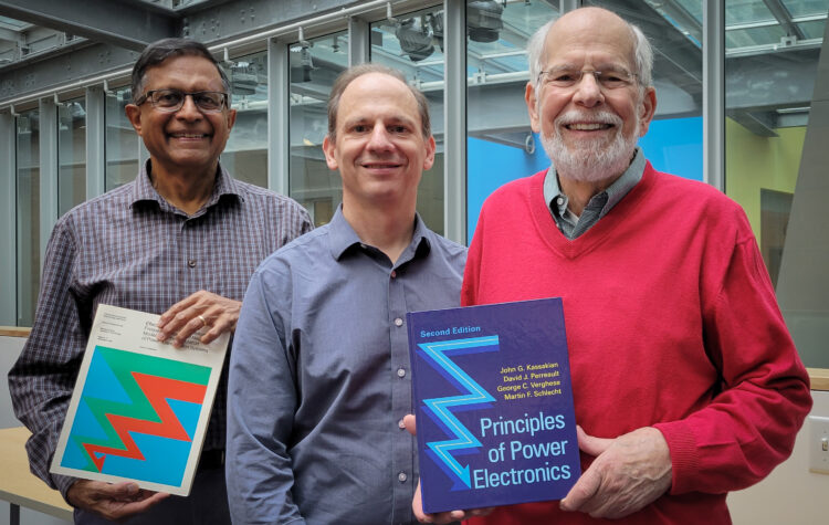 From left to right: George Verghese, David Perreault, and John Kassakian pose with a copy of their new textbook, Principles of Power Electronics (2nd edition).