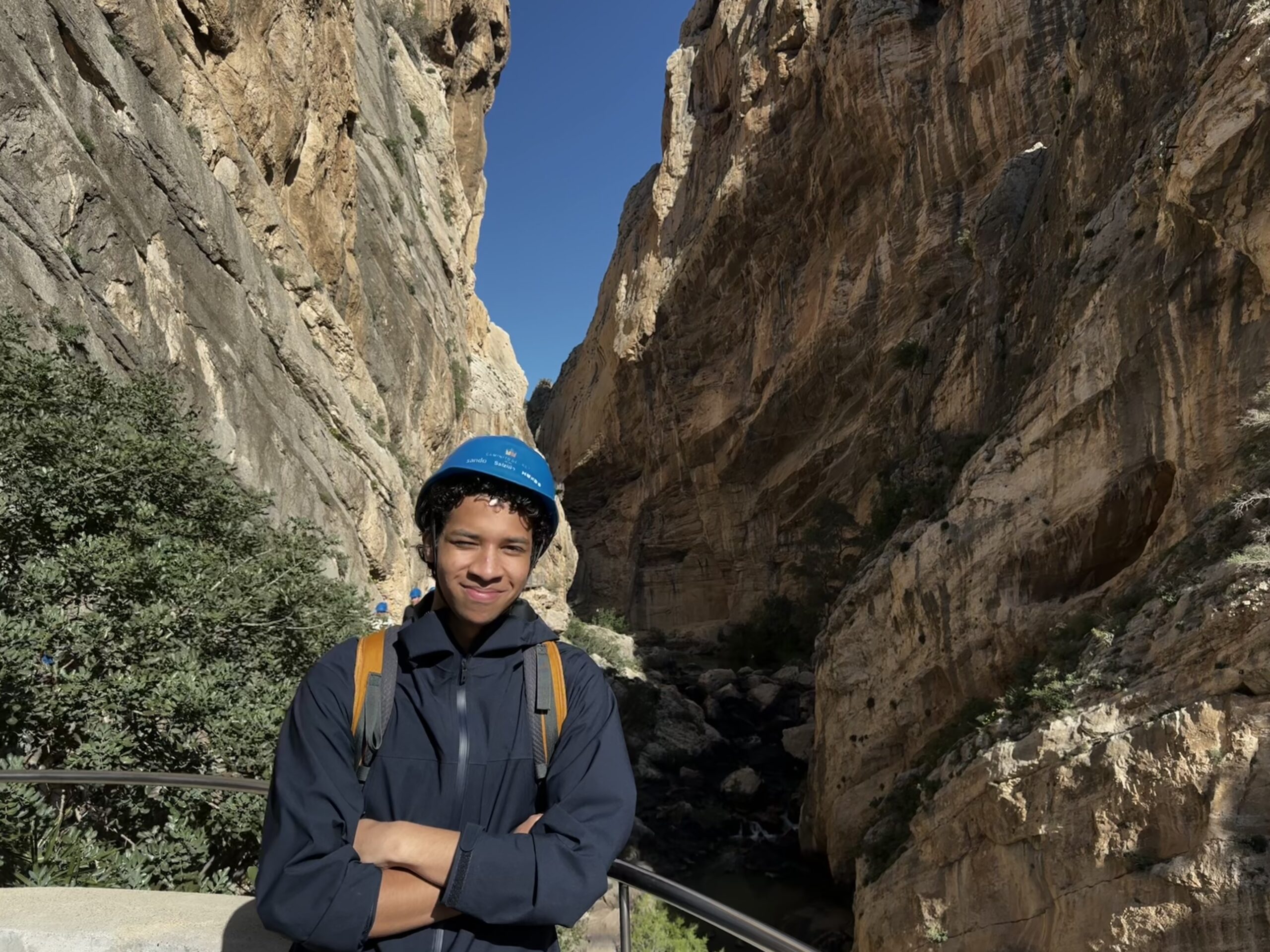 Donavon Clay appears on a hike, wearing a blue rock-climbing helmet.